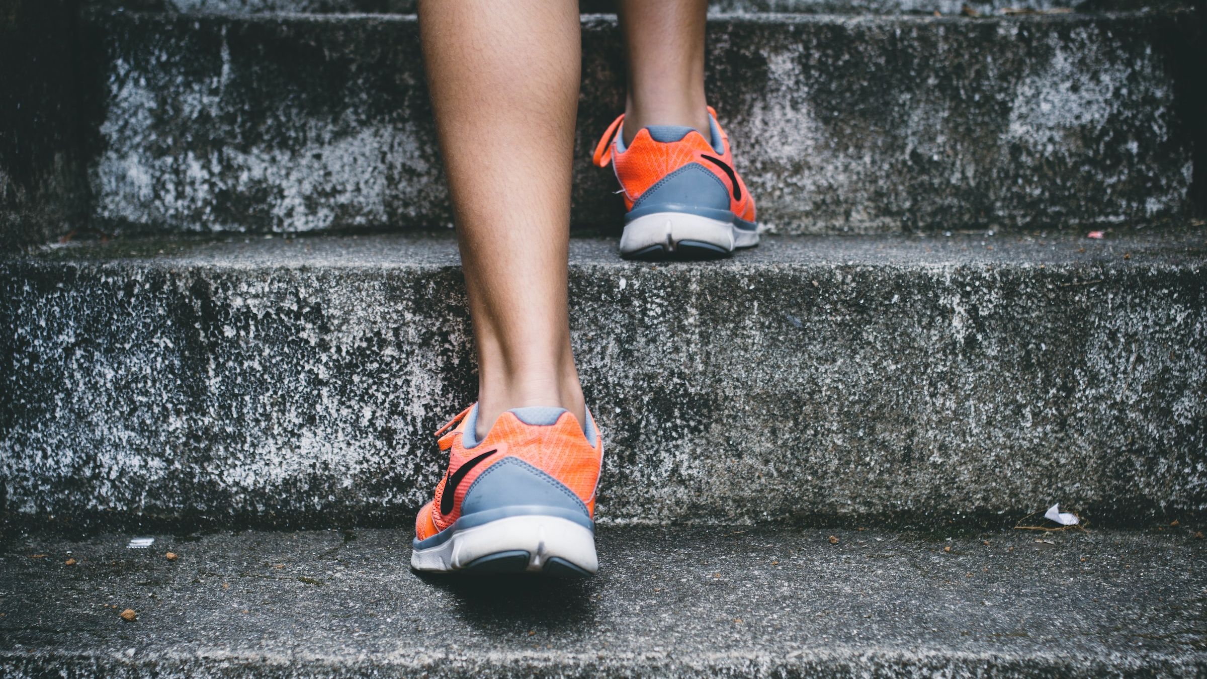 Feet in sneakers going up stairs