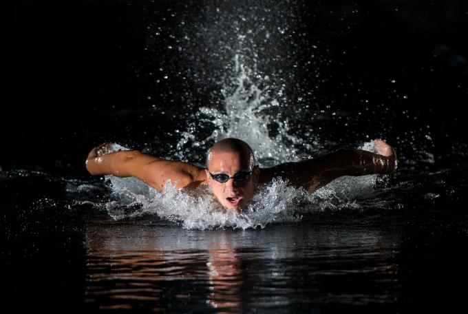 swimmer doing butterfly with water splashes